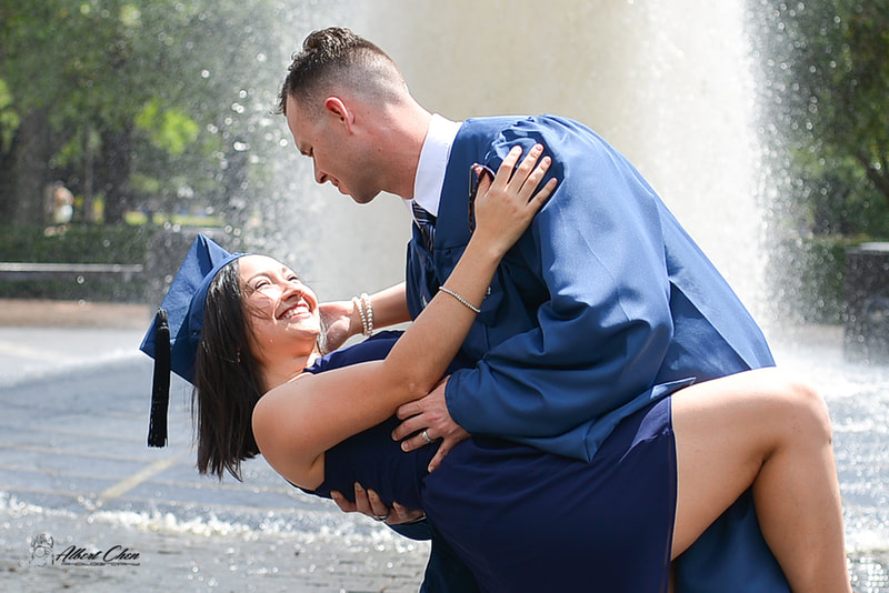 graduation couple in front of water fountain
