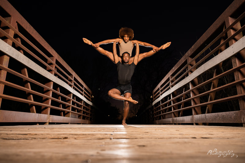 two dancers stacking together