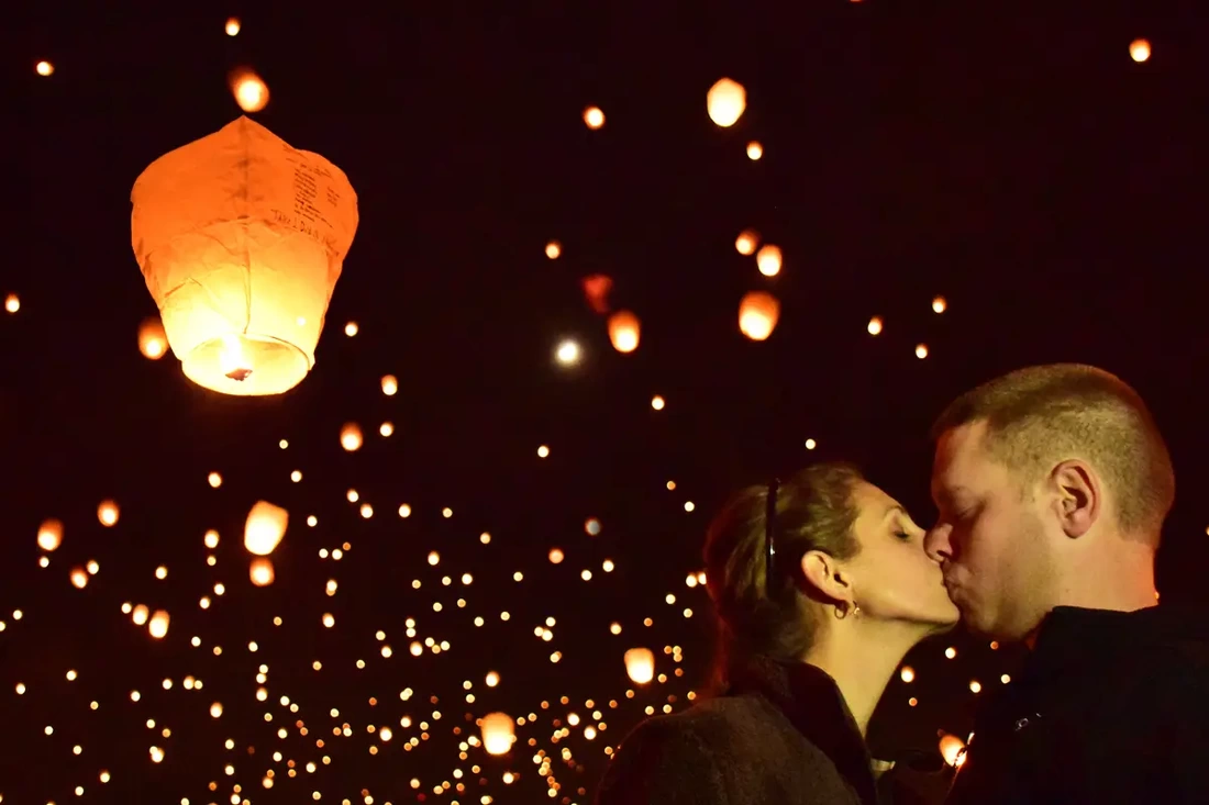 A couple kissing each other at the light festival