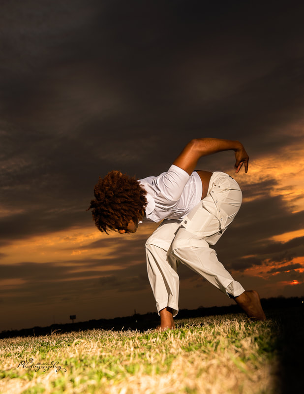 Dancer bend over pose at dusk