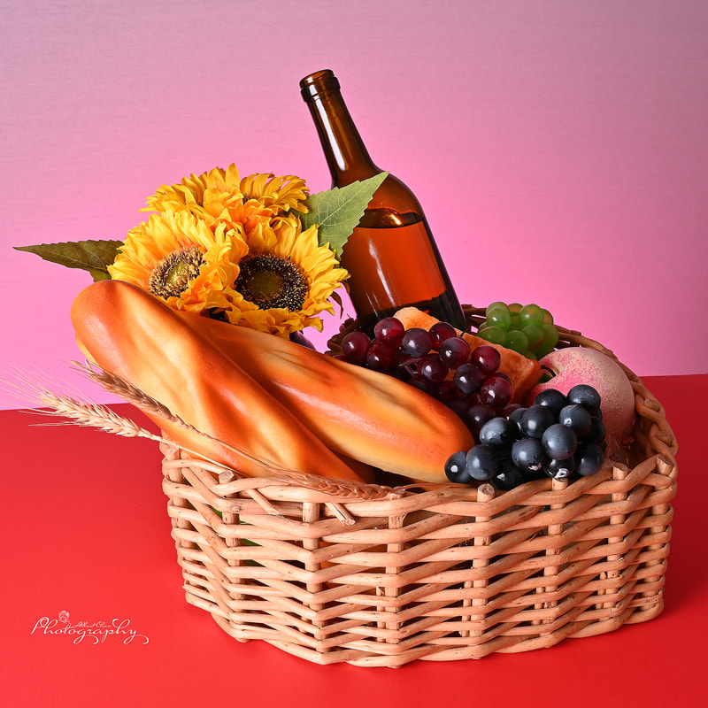 beautiful combination of flowers, wine, fruit and bread with soft colorful background