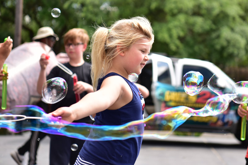 a girl playing bubbles