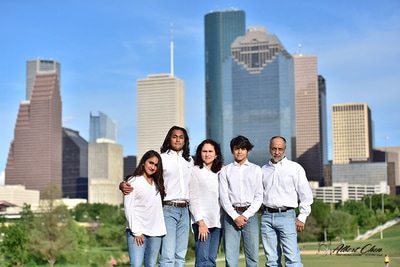 a classic vibe of portrait session for family with downtown at the background